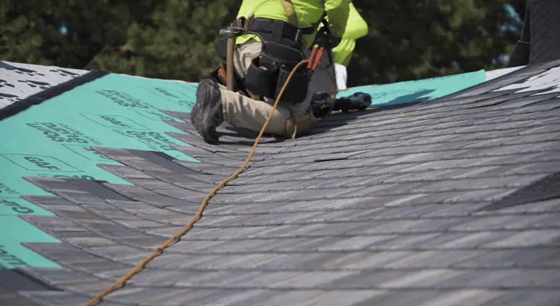 roofer laying f-wave synthetic shingles